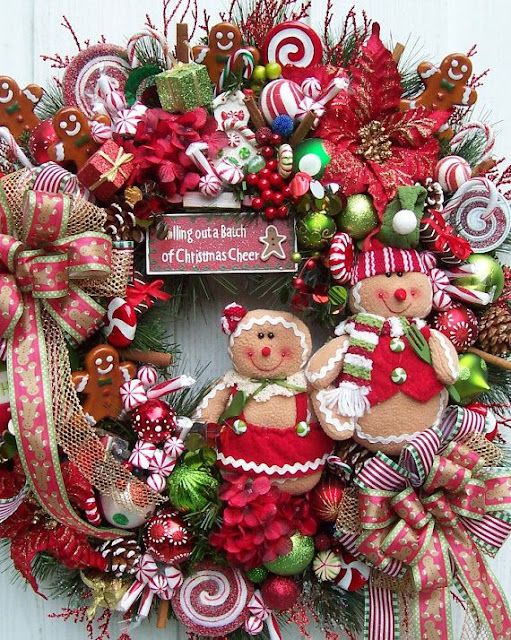 a christmas wreath with two teddy bears and candy canes