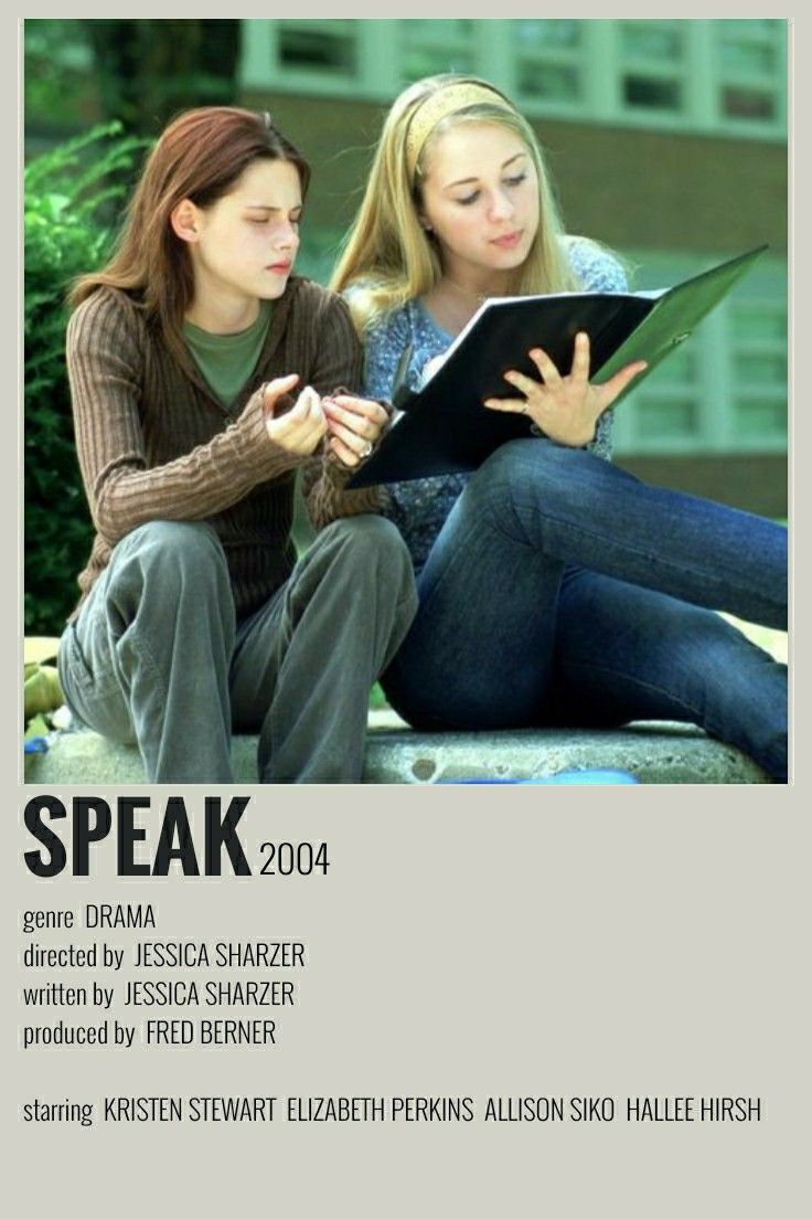 two women sitting on the ground looking at something in their hands and one is reading a book