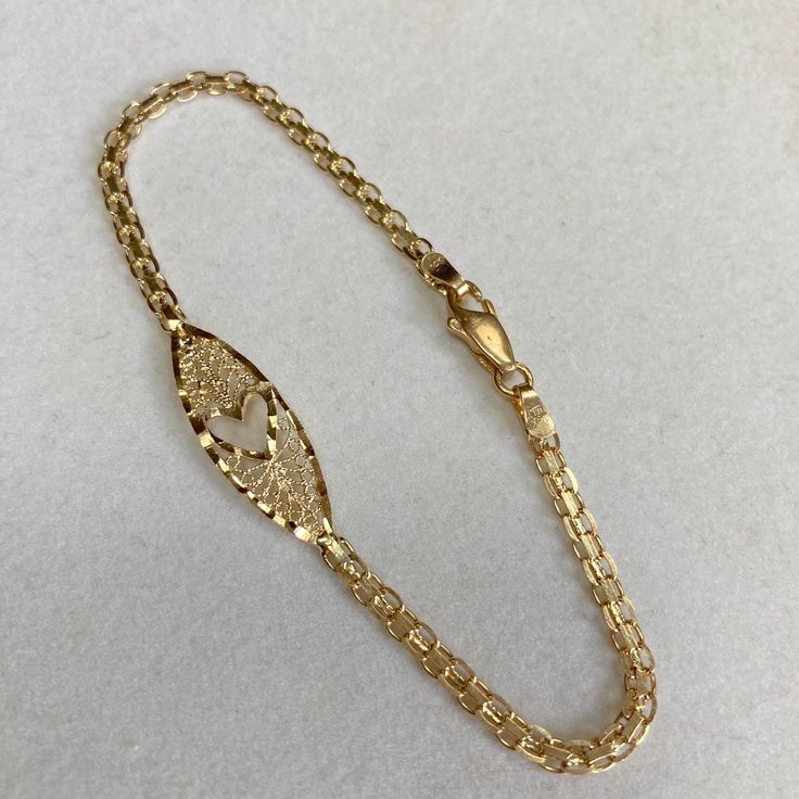 Up for sale is this vintage estate 14 karat solid yellow gold 7" heart cut-out diamond cut ornate filigree 1/8" wide link chain bracelet.  The piece features a diamond cut heart shape cut-out in the center of the filigree center.  The links portion of the bracelet measures approximately 1/8" (3mm) wide.  The bracelet measures 7" long and closes with a lobster claw clasp.  The piece weighs 3.2 grams.  Both end tags are marked 14K ITALY.  Note that some photos are enlarged to show details. Buy wit Heart Cut Out, Link Chain Bracelet, Bracelet Vintage, Solid Yellow, Chain Link Bracelet, Diamond Cut, Link Chain, Heart Shape, Lobster Claw