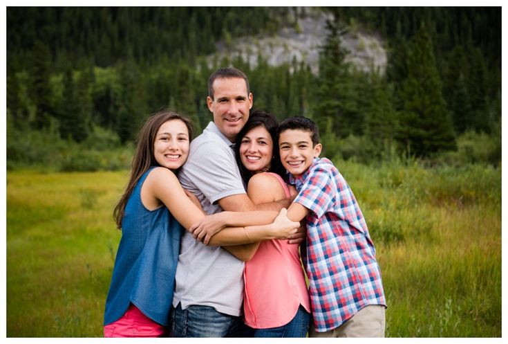 a group of people hugging each other in a field