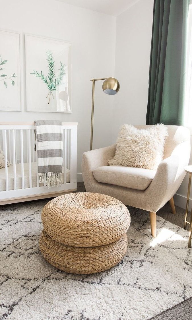 a baby's room with a crib, rocking chair and rug in it