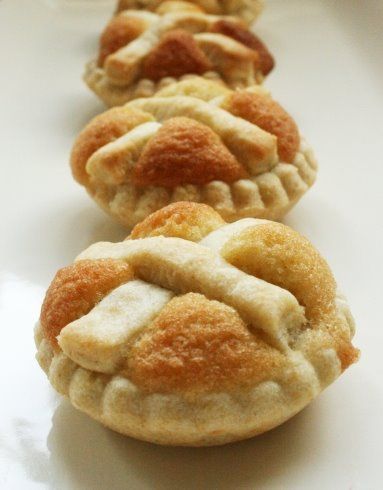 three small pastries sitting on top of a white plate