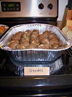 a pan filled with meatballs sitting on top of a stove next to an oven