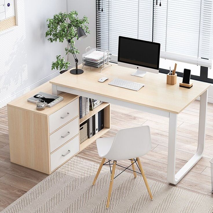 an office desk with a computer and bookshelf next to it on a carpeted floor