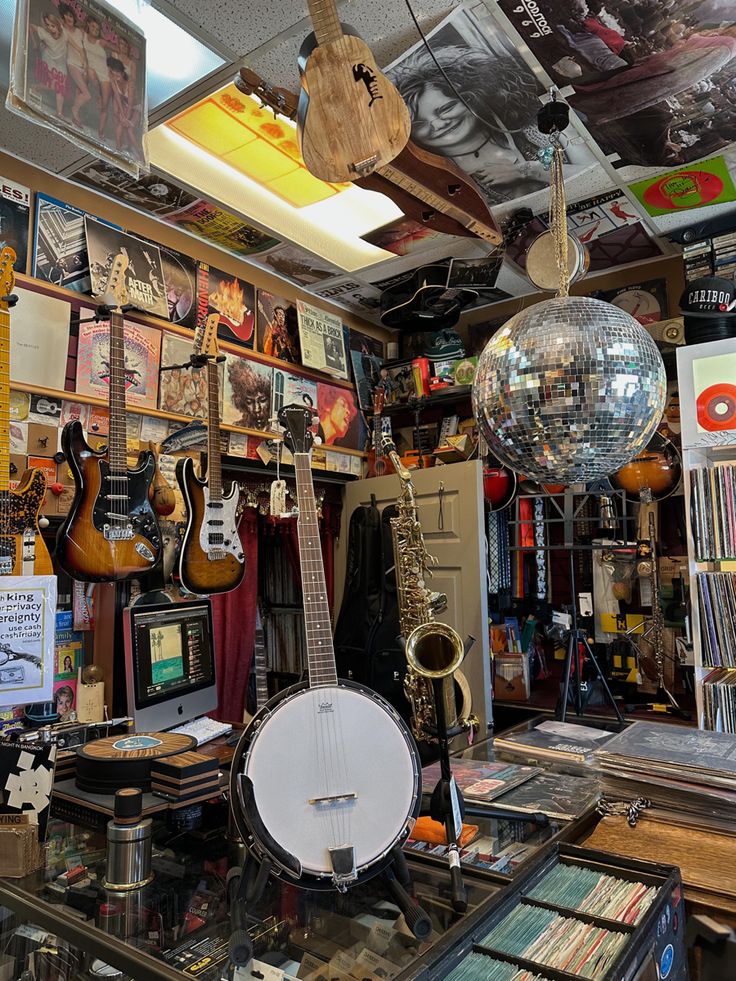 a room filled with lots of musical instruments and disco ball hanging from the ceiling above