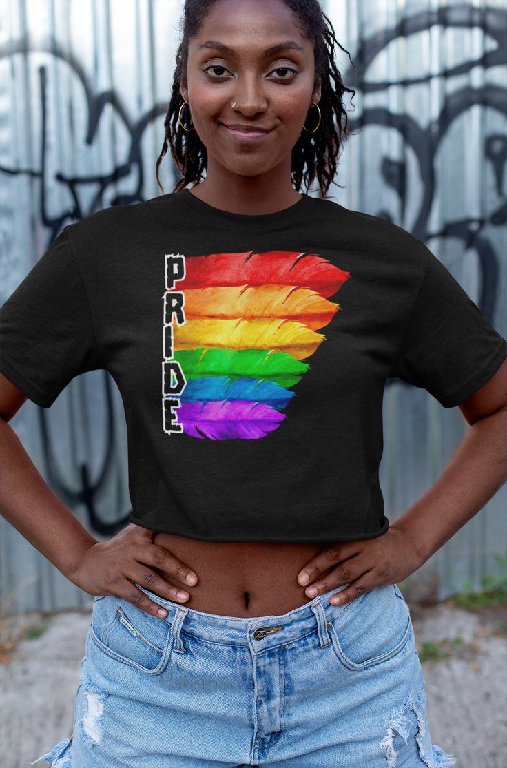 "Rock this soft and comfy Champions Crop Top at your favorite Pride Parade/Celebration. The perfect gift for Pride or everyday is made with 100% cotton, this jersey tee with the signature \"C\" Champion logo patch on the left cuff, durable, double-needle stitching throughout the shirt, and a modern, cropped fit  .: 100% cotton jersey .: Medium fabric  .: Modern cropped fit .: Sewn-in label .: \"C\" logo on the left sleeve .: Comes in other styles .: Please refer to sizing chart Rainbow Feather, Cropped Tee Shirt, Champion Logo, Pride Parade, C Logo, Feather Design, Cropped Tops, Cropped Tube Top, Top Cropped