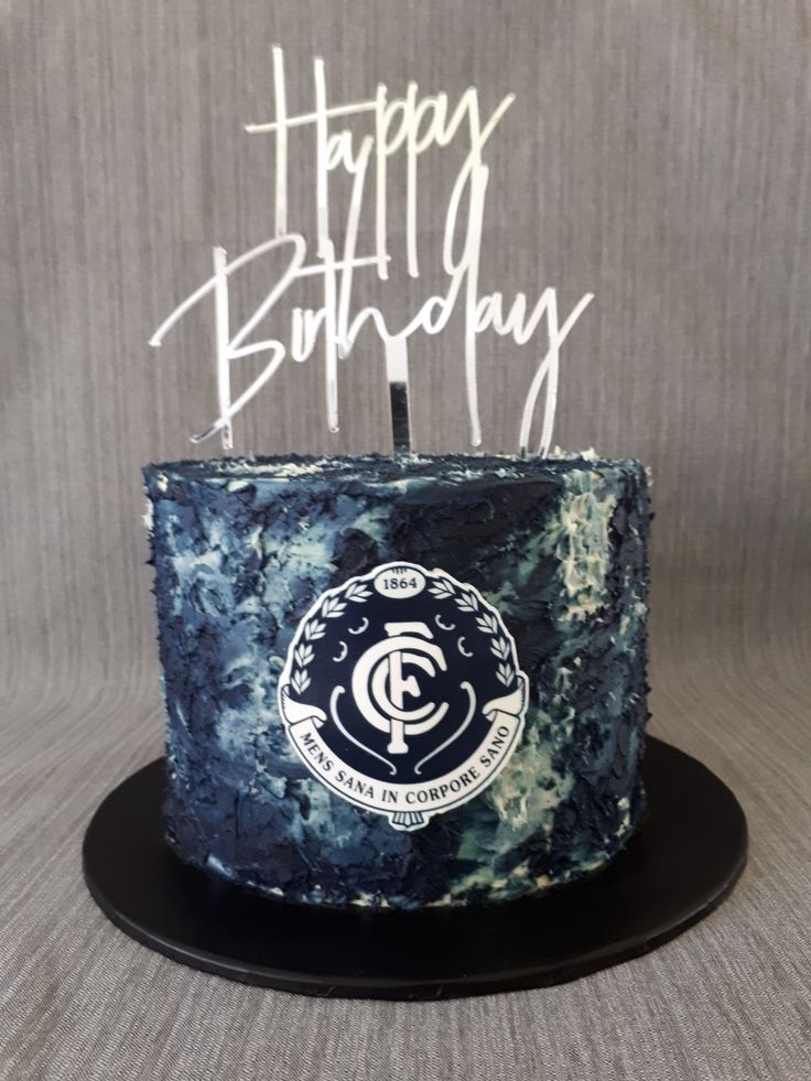 a blue marbled cake with white frosting and the words happy birthday written on it