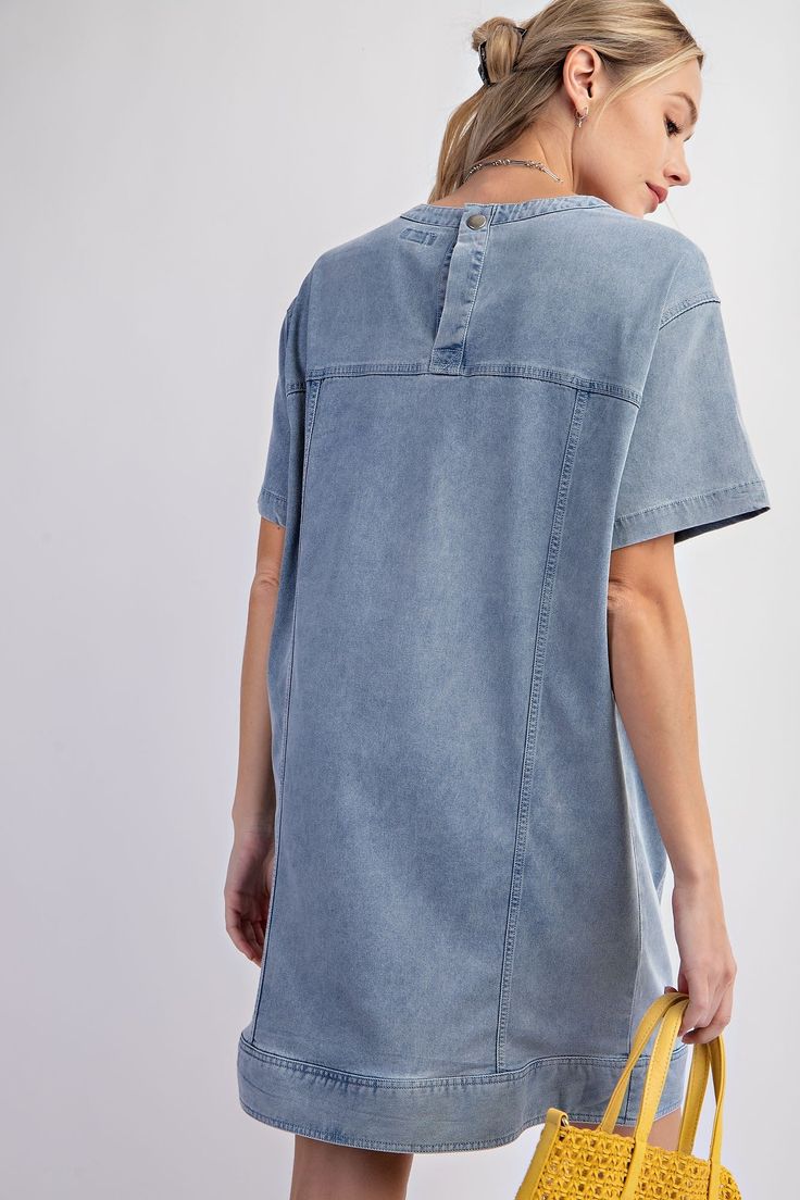 Details Brand: Easel Denim Tunic Dress Mineral Wash Panel Detailing Rounded Neckline Slightly Dropped Shoulders Short Sleeves Front Pockets Snap Back Button Closure Material and Care 97% Cotton 3% Spandex Hand Wash Cold Hang or Line Dry Measurements of Garment Bust of the garment is measured armpit to armpit and then doubled. Length of the garment is measured from the top of the shoulder to the bottom of the hem line. Sleeve Length of the garment is measured from the top part of the shoulder sea Relaxed Fit Washed Denim Dress, Relaxed Fit Denim Dress With Frayed Hem, Casual Washed Blue Chambray Denim Dress, Relaxed Fit Light Wash Denim Dress, Light Wash Relaxed Fit Denim Dress, Dark Wash Mini Length Denim Top, Casual Dark Wash Denim Top In Mini Length, Light Wash Denim Dress With Relaxed Fit, Casual Dark Wash Denim Crop Top