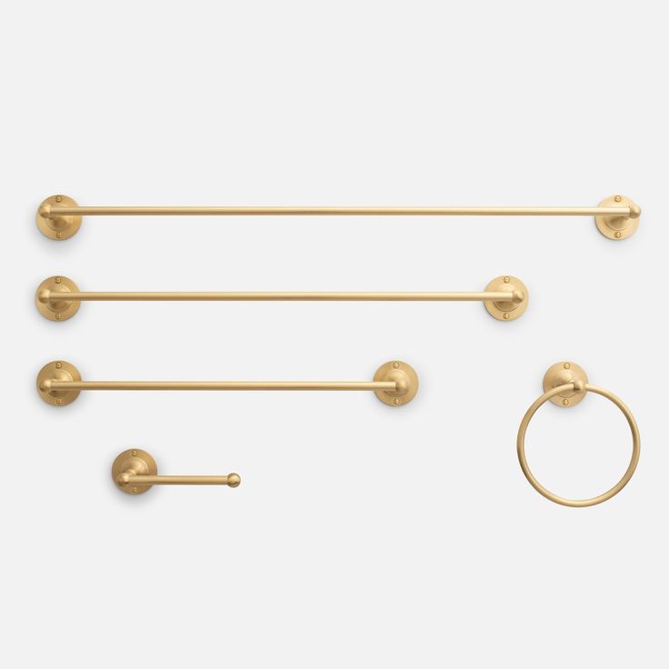 three gold hooks and two rings on a white background