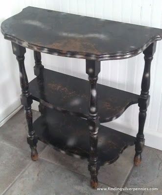 an old wooden table with three shelves on it's sides in a corner next to a wall