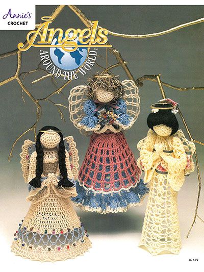 three crocheted dolls standing next to each other in front of a tree branch