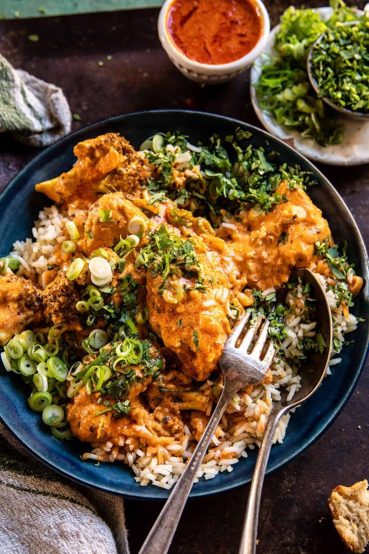 a blue plate topped with chicken and rice