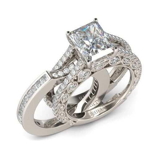 an engagement ring set with a princess cut diamond in the center and side stones on each band