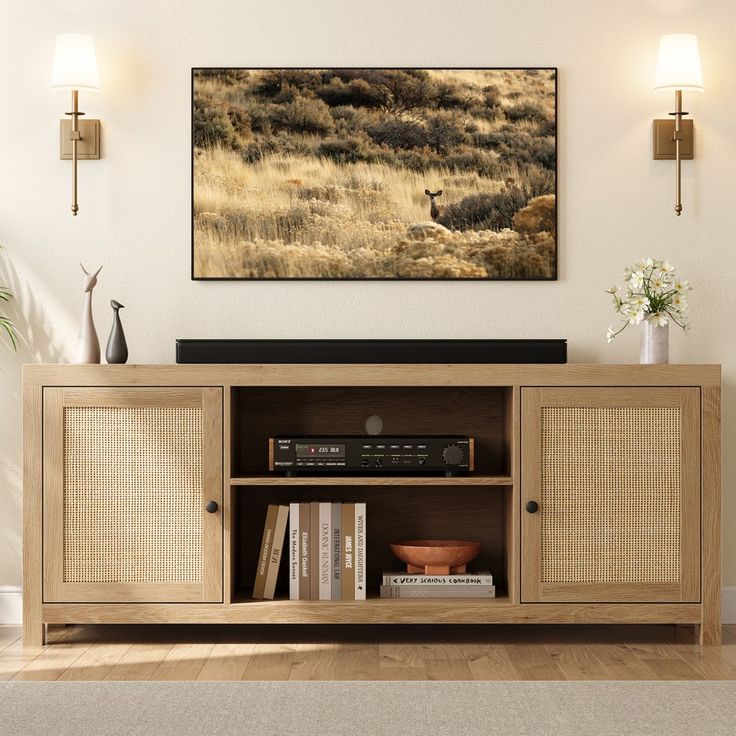 an entertainment center in a living room with a painting on the wall