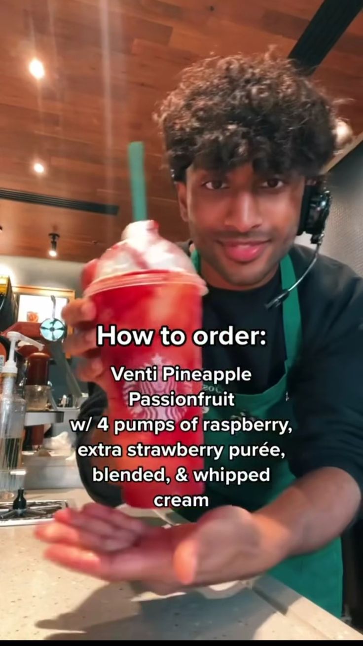 a man holding a drink in his hand with the caption how to order?