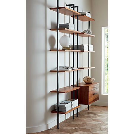 a bookshelf with several shelves on each side and a vase in the middle