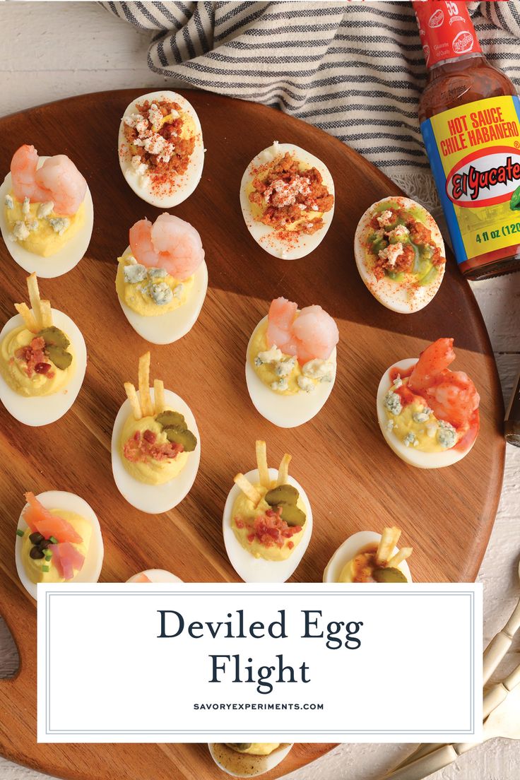 deviled egg flight on a wooden platter with shrimp and crab appetizers