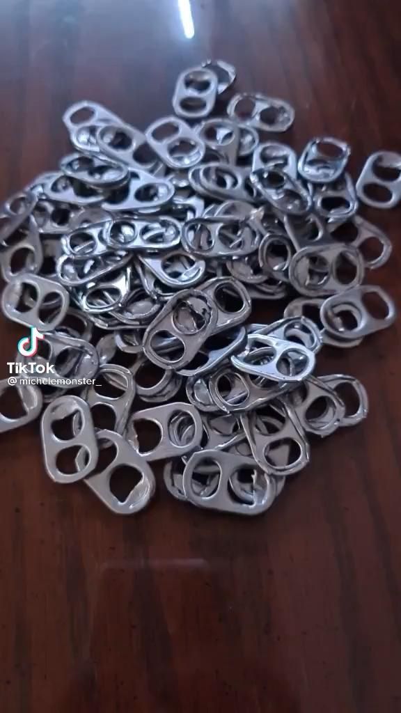 a pile of metal scissors sitting on top of a wooden table