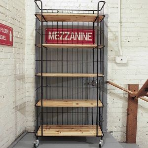 a metal shelf with some wooden shelves on it and a sign that says mezzanine