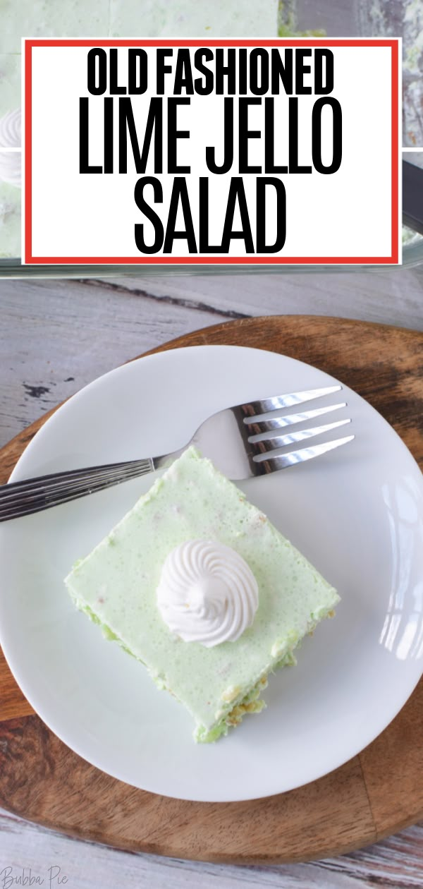 a piece of lime jello salad on a white plate with a fork and knife