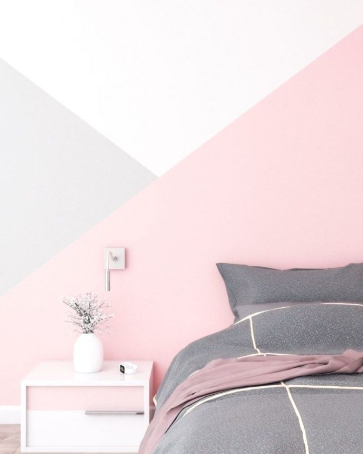 a bedroom with pink and grey wall paint