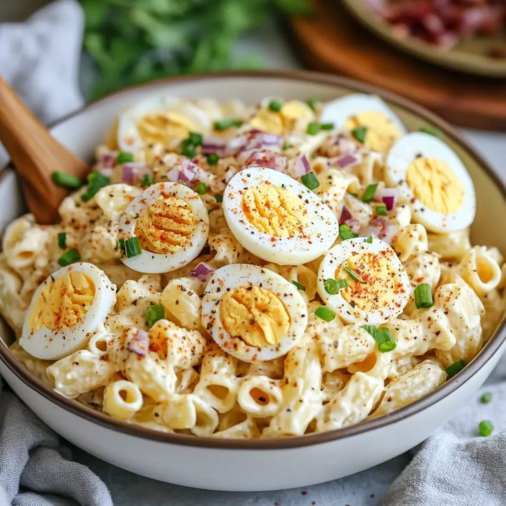 a bowl filled with pasta and boiled eggs