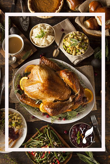 a table full of thanksgiving food including turkey, mashed potatoes, and green beans