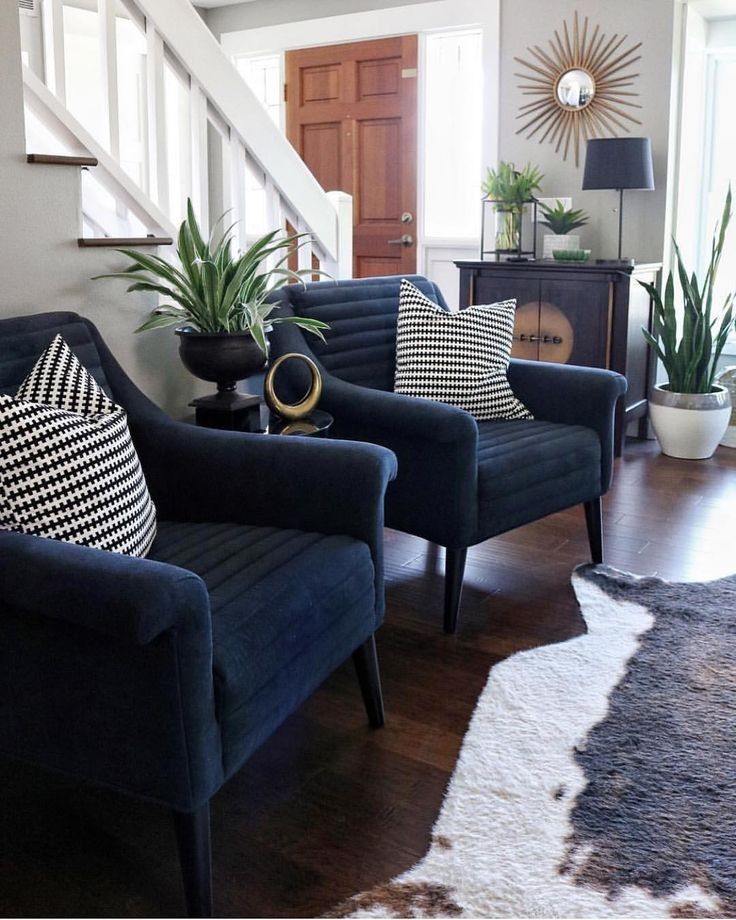 a living room filled with furniture and lots of pillows on top of it's couches