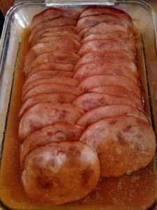 there is a large sausage in the pan on the stove top, ready to be cooked