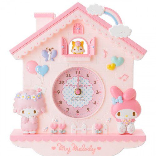 a pink clock with hello kitty decorations on it and the words holiday joy is happening on e