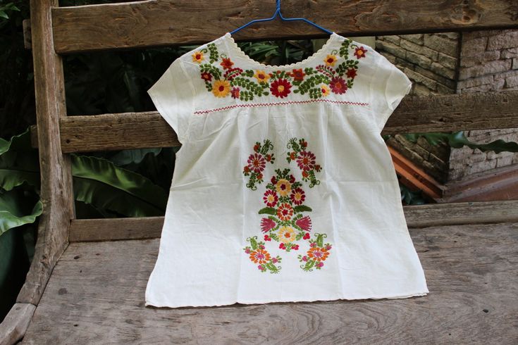 "Here we come again, the Embroidered Top Collection, in larger sizes. Good for M-L Bust & waist 44\" Armhole 21\" Shoulder to shoulder 18\" Length 26\" This is a piece of fantastic handmade, made of 100% Thai soft and light cotton with beautiful hand embroidered flowers details on the neckline, front and shoulder blades.  Pair this beautiful piece with one of Ariel on Earth long tiered ruffle skirt/ Ariel on Earth ruffle wrap skirt or Nothing to Worry long skirt, bohemian jewelry, a pair of stun Ruffle Wrap Skirt, Hand Embroidered Flowers, Tiered Ruffle Skirt, Embroidered Top, Top Collection, Cotton Lights, Wrap Skirt, Embroidered Flowers, Embroidery Flowers