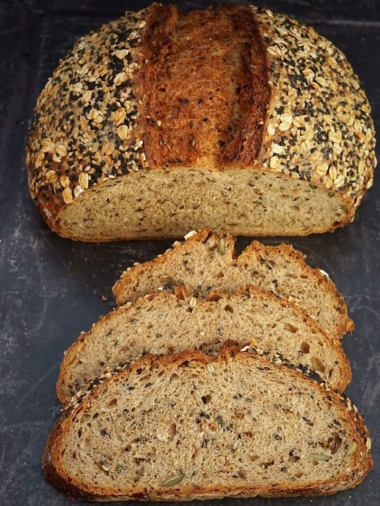 sliced loafs of bread sitting on top of a black countertop next to each other