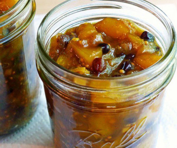 two jars filled with food sitting on top of a table