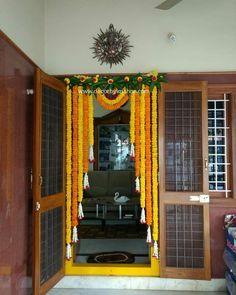 an entrance to a house decorated with flowers and garlands