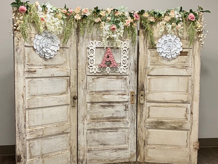 an old wooden door decorated with flowers and lace