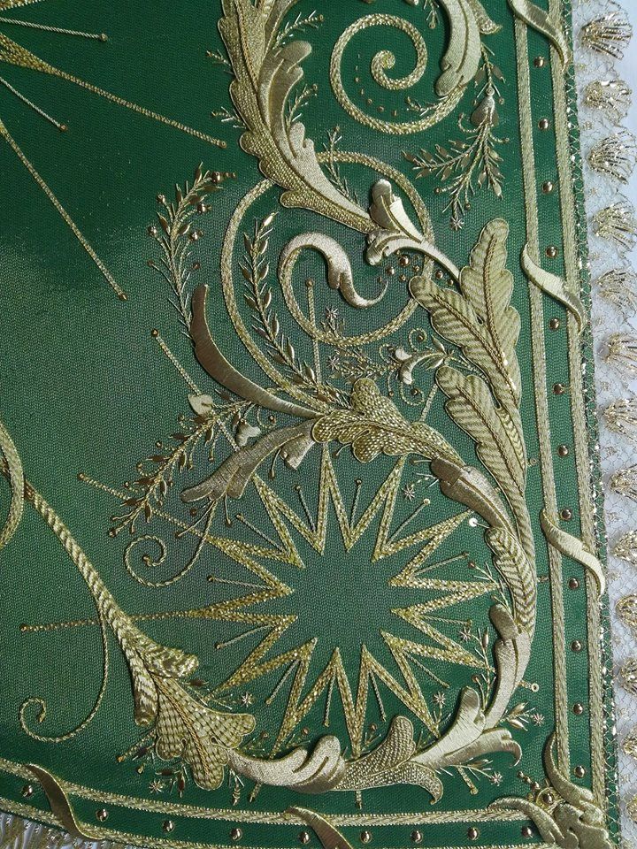 an intricately designed green and gold book cover with decorative designs on the front side