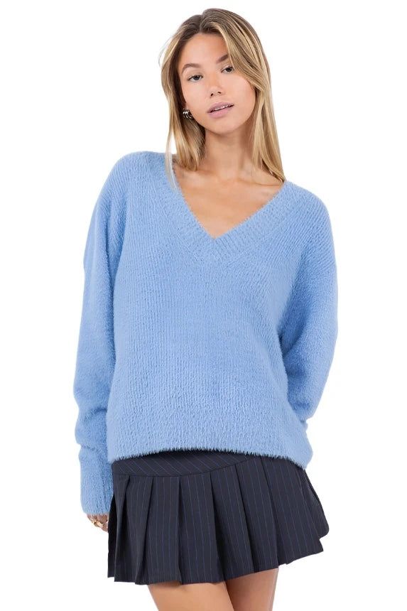 Cozy up in style with our Mohair V-Neck Sweater. Crafted for warmth and comfort, this sweater features a luxurious mohair blend that offers a soft and cozy feel. Perfect for chilly days, it's ideal for layering over shirts or pairing with jeans for a timeless and relaxed look. Shop more Sweaters Model is wearing Extra small Blue Mohair yarn V-neck Long sleeves Ribbed hem 74% Acrylic / 22% Polyester / 4% Elastane Still not sure which size to get? Ask one of our stylists! Please give us a call at V Neck Sweaters, White Jumpsuit Dress, Mohair Yarn, Light Blue Sweater, Sweaters Online, Blue Sweater, Denim Leggings, Short Rompers, V Neck Sweater