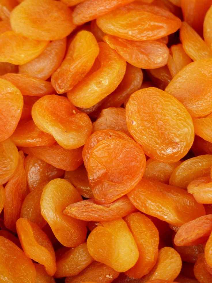 close up view of peeled and unpeeled apricots, which are orange