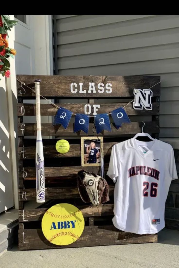 a baseball bat, glove and jersey are on display in front of a sign that says class of 2012