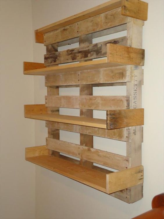 a wall mounted shelf made out of wooden pallets