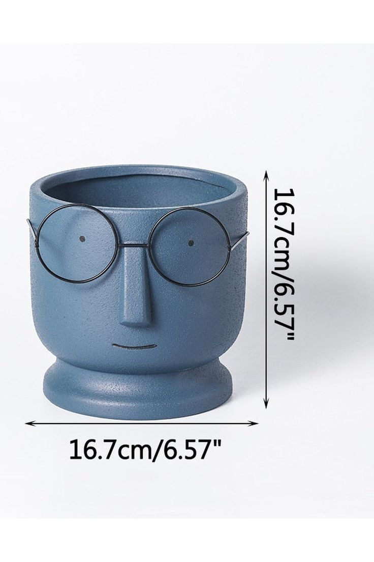 a blue ceramic cup with glasses on it