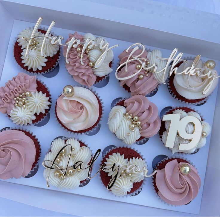 a box filled with lots of cupcakes covered in frosting