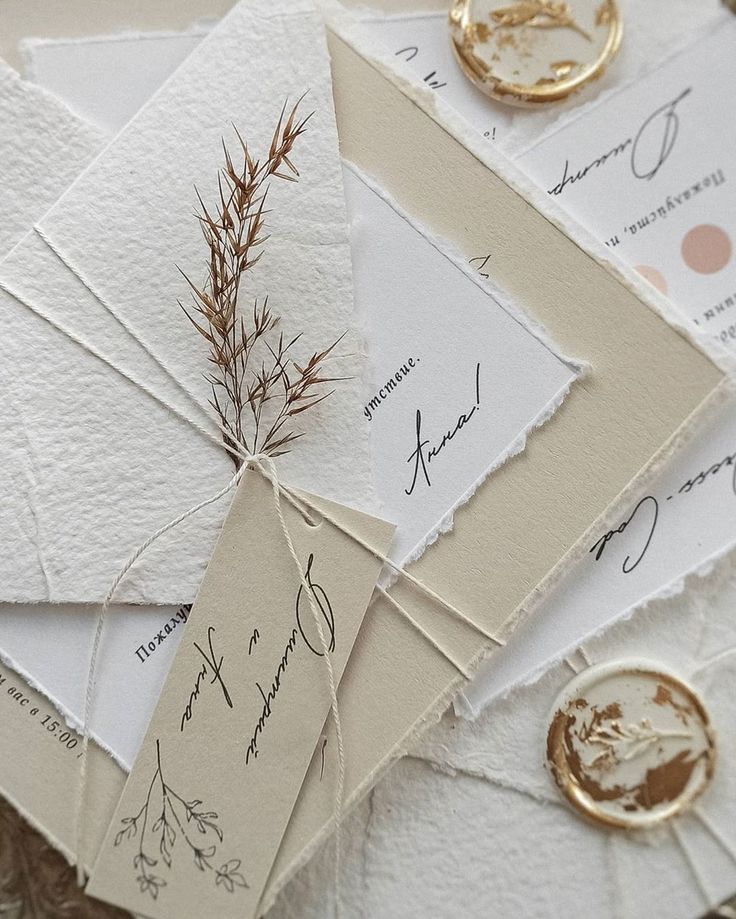 the wedding stationery is laid out on top of each other