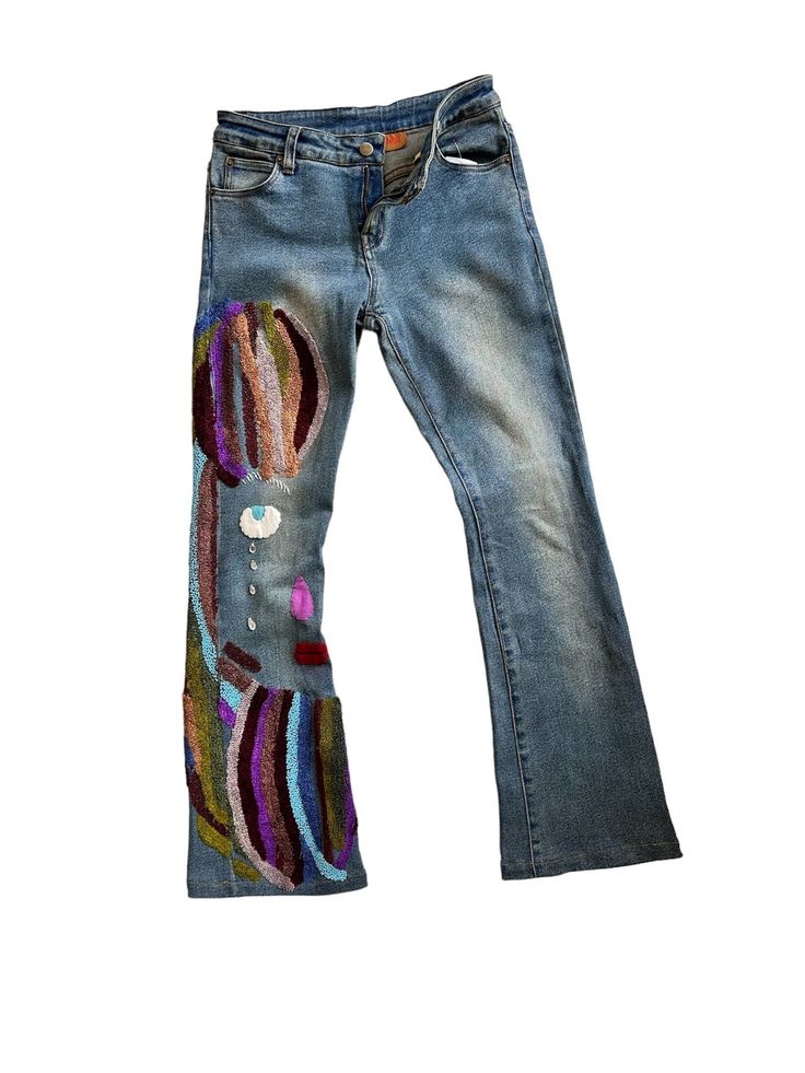 a pair of jeans with colorful patches on them