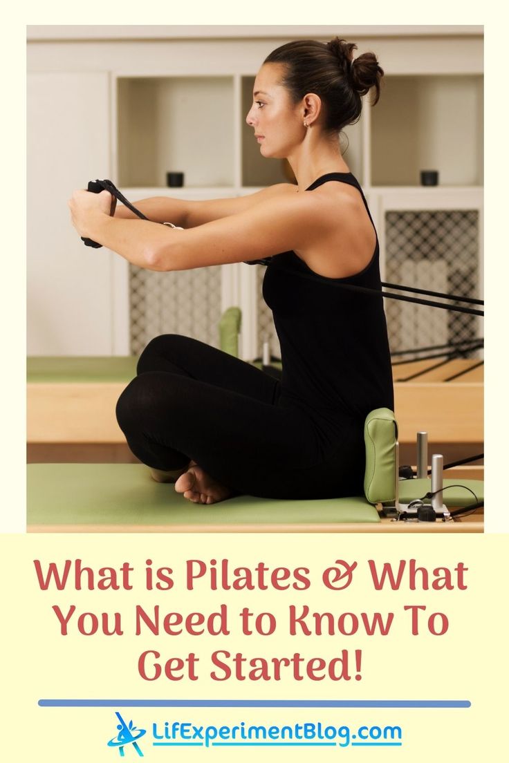 a woman sitting on the floor holding a pair of scissors