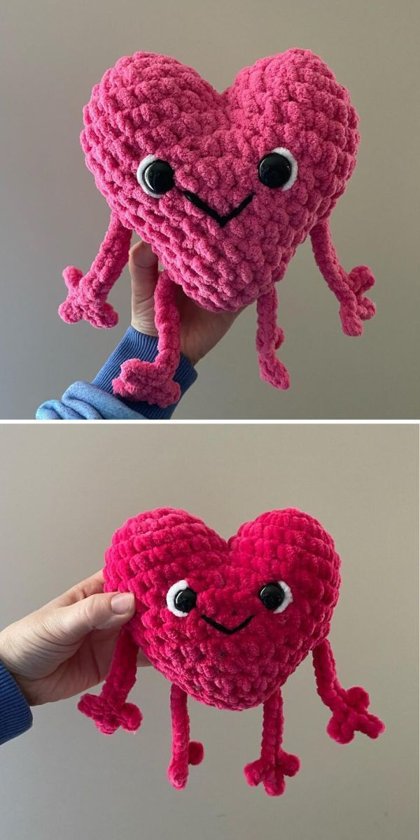 there is a pink crocheted heart that has eyes and hands holding it up