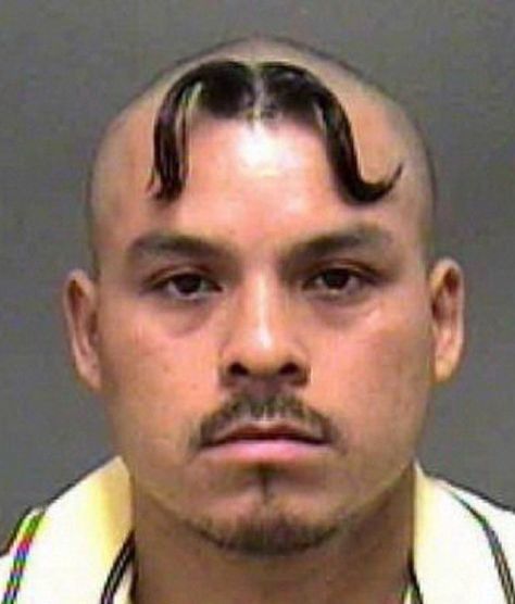 a man with a moustache on his head is shown in this mug shot