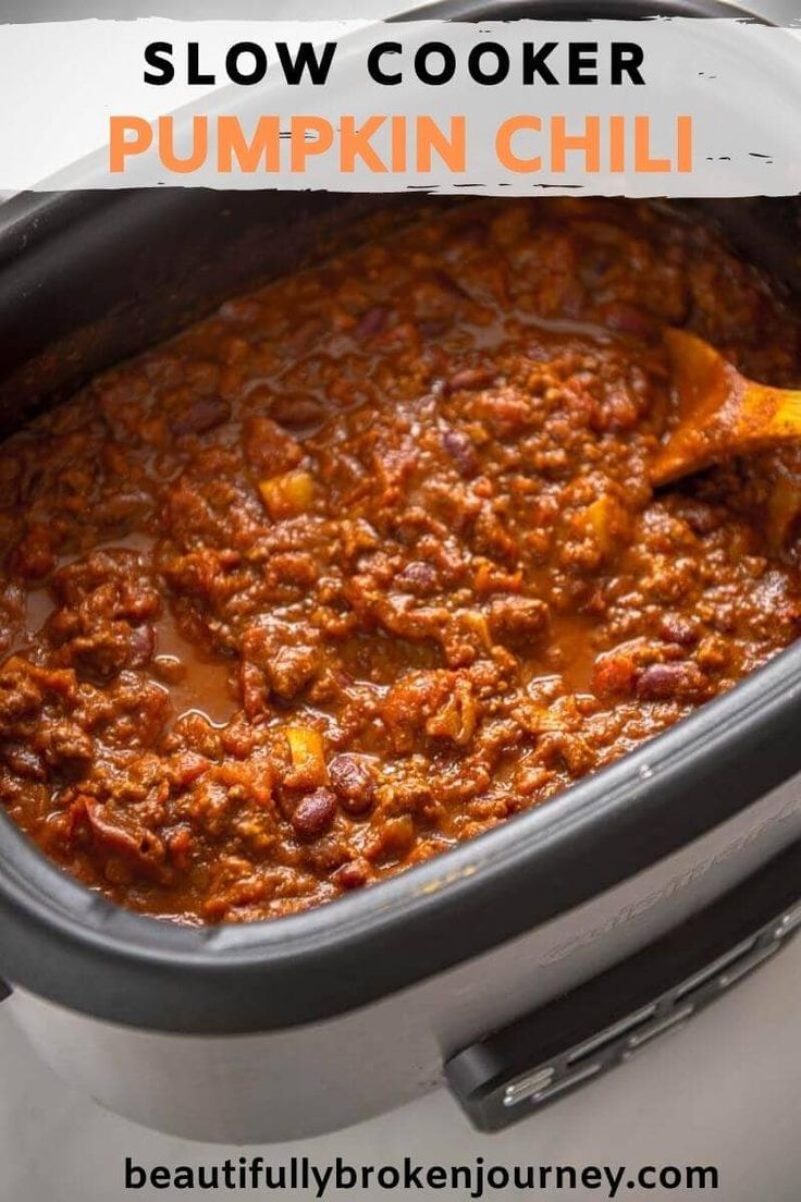 a slow cooker filled with chili and meat, ready to be cooked in the oven