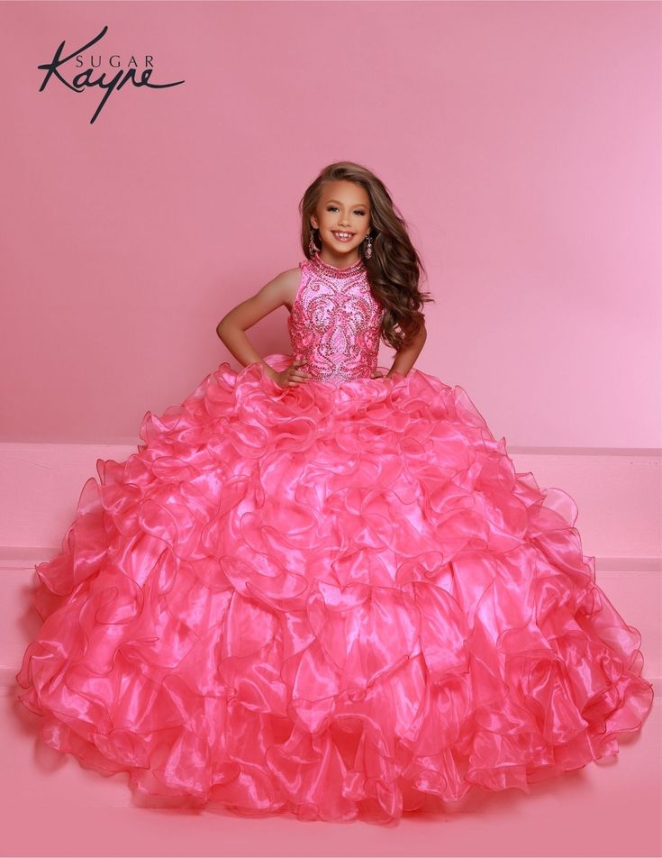 The elegant and sophisticated Sugar Kayne C328 Girls Preteens Pageant Dress boasts a dazzling halter neckline and full ruffle ball gown skirt with a crystal bodice, perfect for making a memorable fashion statement. Be sure to steal hearts in this organza ballgown. Shine like a diamond with the sequin and stones bejeweled bodice and high neck detail, complete with voluminous layers of organza on the skirt. Colors: Barbie Pink, Cinderella Blue, Yellow Sizes: 2, 4, 6, 8, 10, 12, 14, 16 (Sizes 2-6 d Ruffle Ball Gown, Ruffled Long Skirt, Shine Like A Diamond, Johnathan Kayne, Jasz Couture, Girls Pageant Dresses, Ball Gown Skirt, Beaded Bodice, Prom Dress Shopping