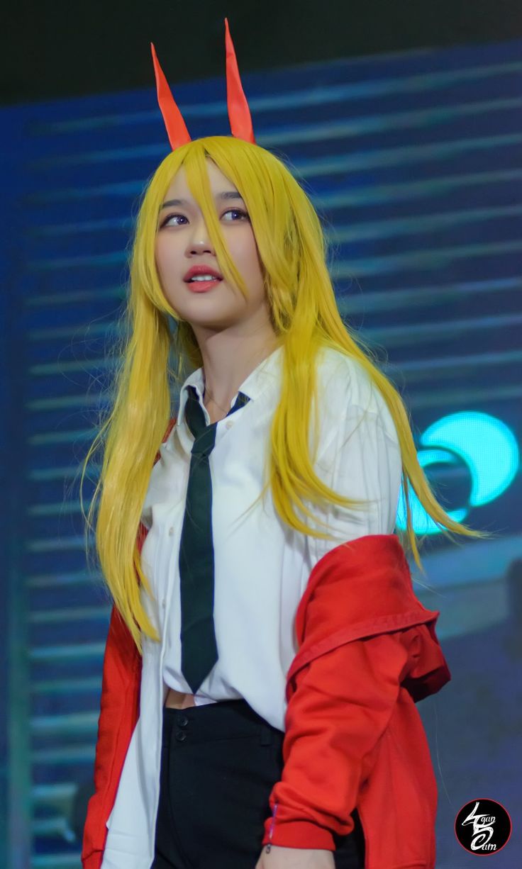 a woman with long yellow hair and horns on her head